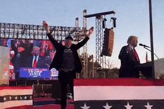Musk jumping up and down at a Trump rally