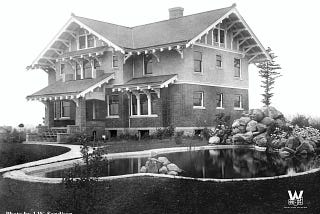 old, black and white photo of the Roeder Home with pond in the front yard