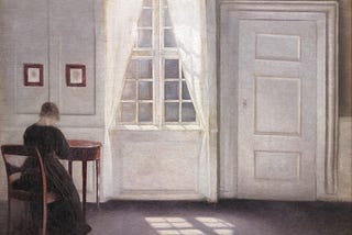 A painting of a woman sat at a desk next to a window, sunlight falls into the room and across the floor beside her. Painted by Vilhelm Hammershøi