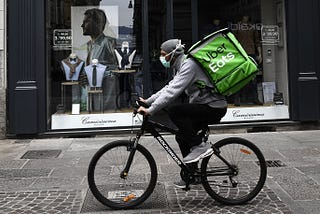 An UberEats delivery-person on a bike.