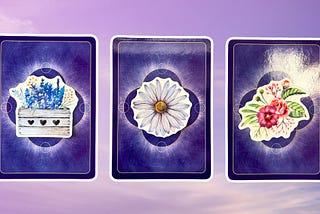 Three oracle pick a card piles: pile 1 — blue flowers, pile 2 — white flower, and pile 3 — pink flowers