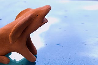 A clay sculpture of an ambiguous animal gives a long, silent howl of indignation.