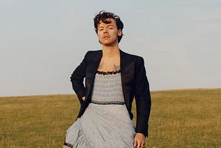 A picture of Harry Styles in a light blue dress from his Vogue photoshoot