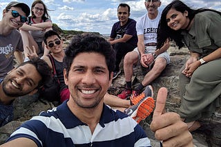 Picture of the author and six younger colleagues at a beach in Maine.