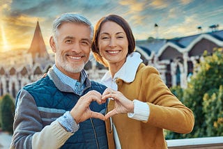 AI image of a man and woman making a heart symbol with their hands.