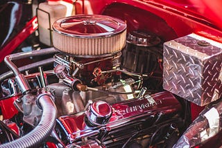 A display of a clean red car engine.