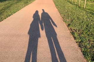 shadow of a couple holding hands