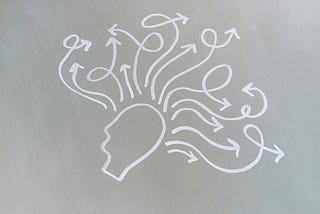 Artistic presentation of a persons head with thoughts emerging and taking different paths.