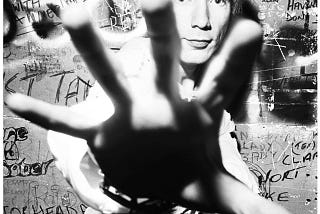 Photographer Dennis Morris captures John Lydon of The Sex Pistols backstage at Marquee Club, London, 1977, taken on Leica M3 with 35mm wide angle lens.