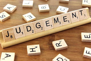 scrabble tiles spelling judgement