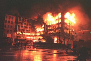 A building burning because of the NATO airstrikes.