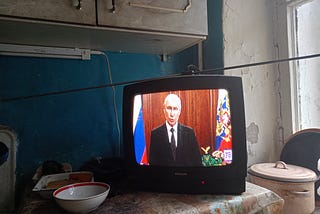 Vladimir Putin, President of Russia, is seen on TV as he addresses Russian citizens about PMC Wagner in June 2023.