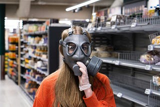 Hardware store employee trying on gasmask.