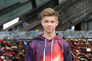 young man standing in front of graffiti