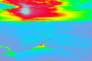 The same image of the landscape presented before, but in thermal infrared imagery color scheme: red-green-yellow-blue