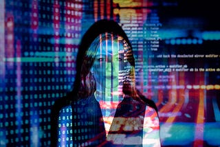 A picture of computer code projected over the face of a woman.
