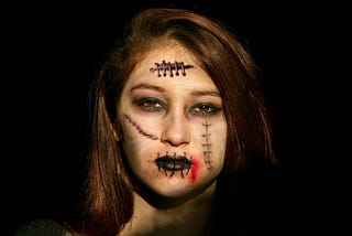 Halloween makeup — scars upon a beautiful woman’s face.