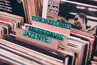 Pictured from a record store, in the Jazz section with lots of vinyl sleeves to sift through.