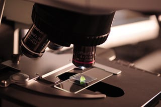 Close up of a microscope looking at a sample