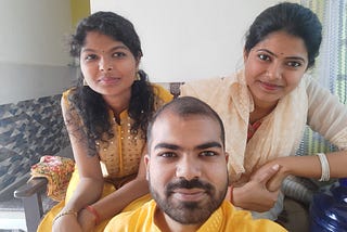 This image is of myself and my sisters sitting together after a family function. Our attire is mostly yellow with a sweet smile on everyone’s face. I am lucky to have them. This is a selfie taken in 2024. — alt text to boost Medium stories.