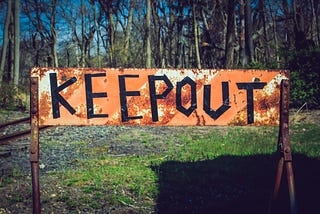 Keep out sign with a forest in the background