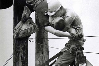 Taken in 1967 by Rocco Morabito, this photo called “The Kiss of Life” shows a utility worker named J.D. Thompson giving mouth-to-mouth to co-worker Randall G while both half-way up a utility pole.