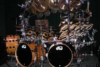 An extremely elaborate drum kit sits on stage after a concert