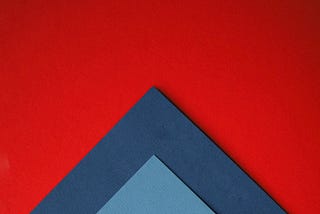 A close up of two different colours of paper