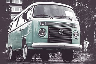 a mint Volkswagen van with monochrome surroundings