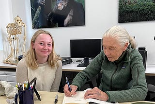 Jane Goodall (right) signs a book for Global Futures student Reilly Hammond.