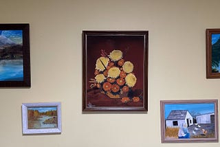 a white wall with framed art displayed