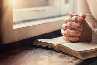 Hands clasped in prayer