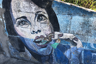 woman eats shrimp. Mural on wall