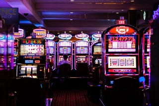 Man sitting at slot machines in a casino — Davis Law