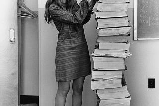 Hamilton in 1969, standing next to listings of the software she and her MIT team produced for the Apollo projec