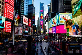 Photograph of New York City’s Times Square at night with many ads in background