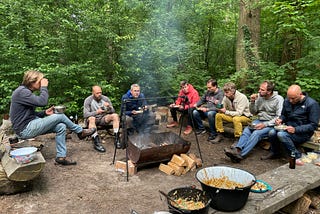 Friends eating around a fire