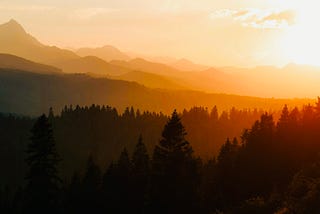 Sunset over layers of mountains and forest