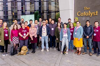 Most of the Newcastle University RSE Team (about 30 people) standing outside the Catalyst building. Some of them are wearing RSECon24 t-shirts.