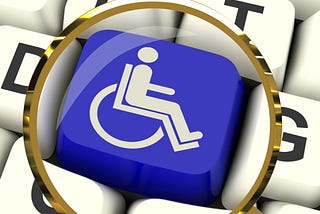 Keyboard with image of user in wheelchair on key and a magnifying glass