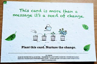 a card with text and illustration of a plant growing