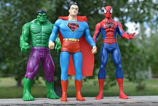 Three miniature superhero toys