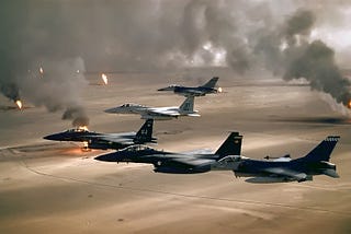 U.S. Air Force F-15s and F-16s fly over the burning oil fields of Kuwait. Airman Magazine via Flickr.