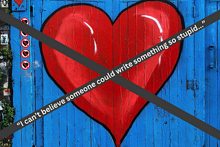 A red heart graffitied on a wall with a big black “X” through it. The X says, “I can’t believe somone could write something so stupid.”