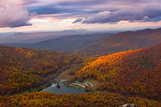 lake in a valley between the mountains in autumn