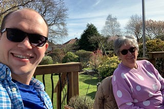 My nan sitting in the garden smiling after months apart