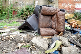 Fly tipped sofa and wreckage