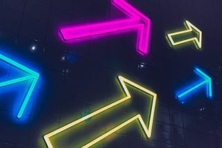 A collection of neon arrows pointing to the right.
