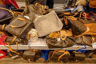 a display of fake Louis Vuitton bags