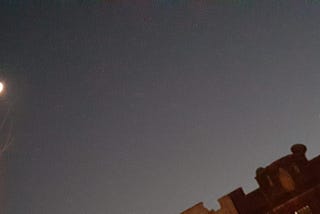 The Great Conjunction: Saturn meets Jupiter with the moon in the night sky.